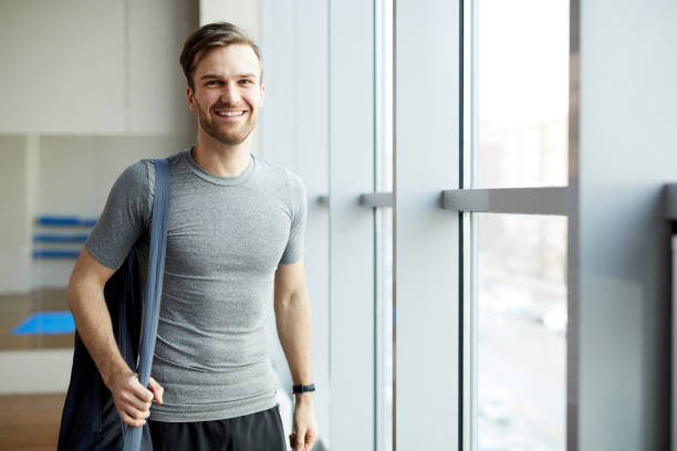 istock Cheerful man with yoga mat bag 1141511903