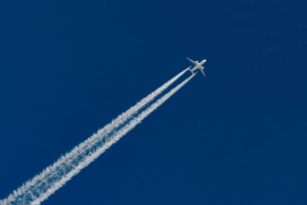 istock Airplanes leaving contrail trace on a clear blue sky. 1141512188