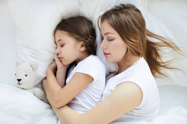 istock Woman Sleeping with Child Above View 1141513722