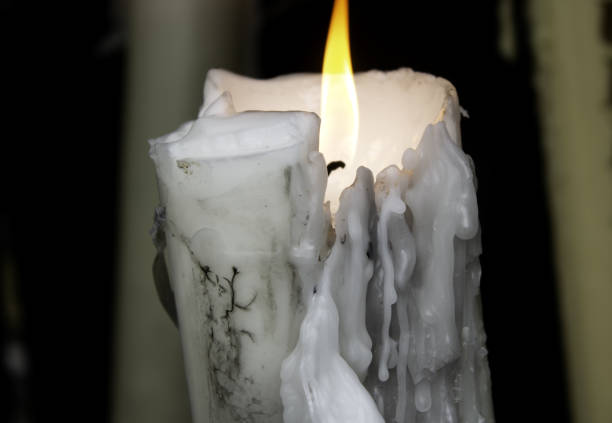 Candles lit in chapel of Lourdes, religious symbols and terrorism