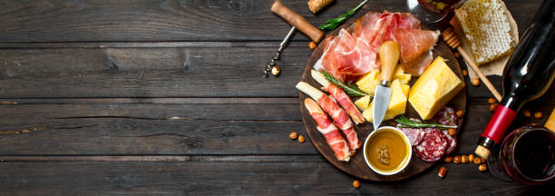 istock Antipasto background.Various meat and cheese snacks with red wine. 1141514788