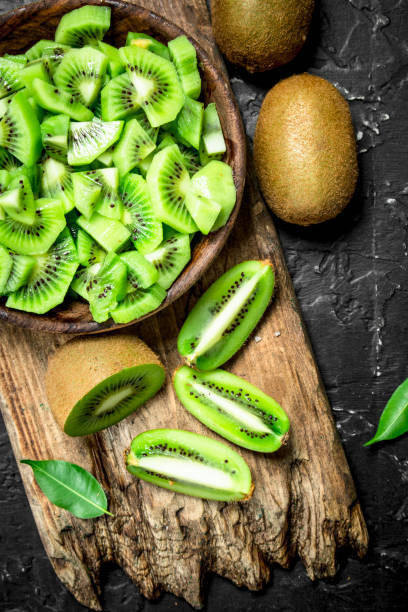 istock Kiwi slices in a bowl on a cutting Board. 1141514801