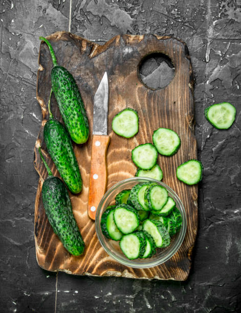 istock Sliced cucumbers on a cutting Board with a knife. 1141515362
