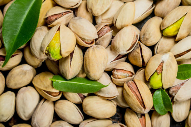 istock Pistachios with leaves texture . 1141516928