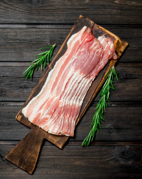 istock Raw bacon with rosemary. 1141517035