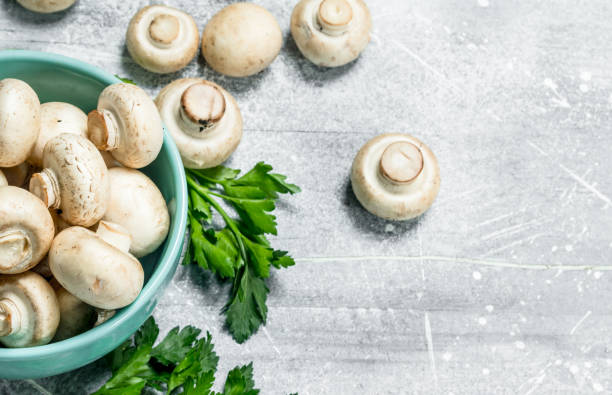 istock Ripe mushrooms in a bowl with foliage. 1141517038