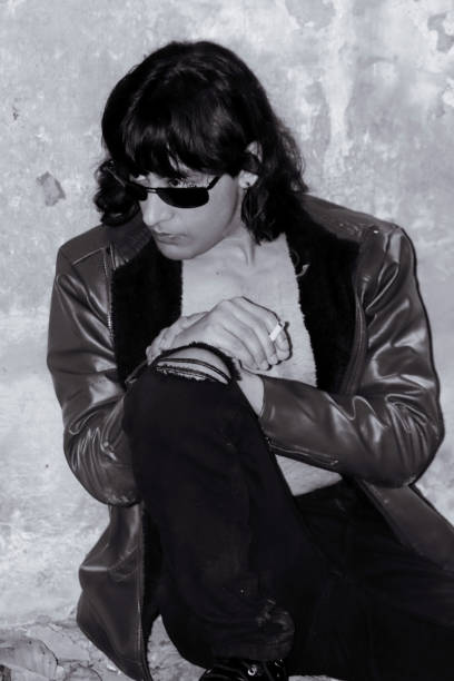 Rough Fashion Trends/Indian Men Model with bob cut long haired Wearing brown Jacket Ripped jeans/Man model Smoking attitude