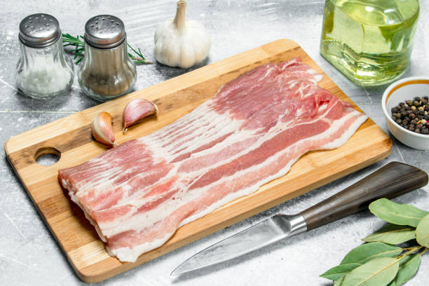 istock Raw bacon with spices and herbs. 1141517339
