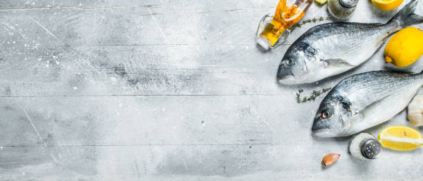 istock Raw sea fish with lemon wedges and spices. 1141518051