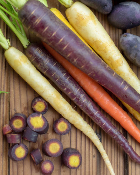 istock Colorful rainbow carrots on rustic wood table 1141519026