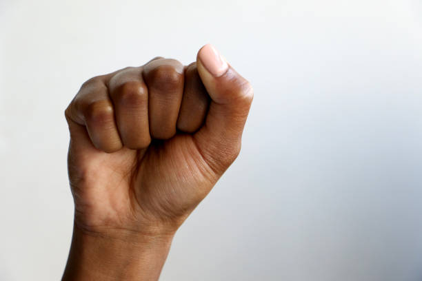 Isolated black African hand clenched in a fist photographed for political and revolutionary purposes