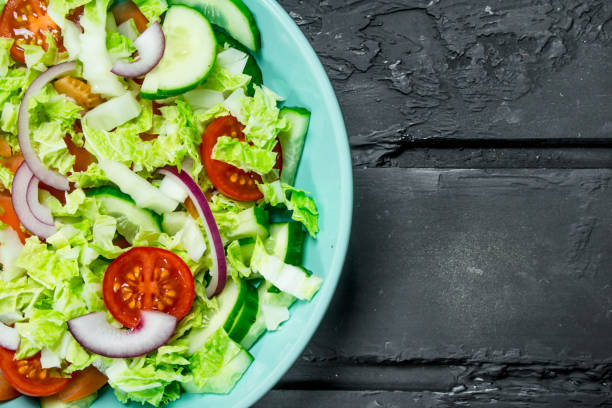 istock Fresh vegetable salad of tomatoes, cucumbers and red onions. 1141519921
