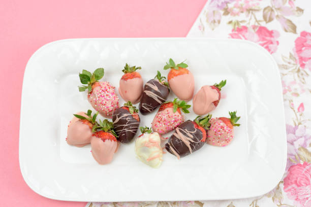 istock Decorated chocolate dipped strawberries on white plate 1141520232