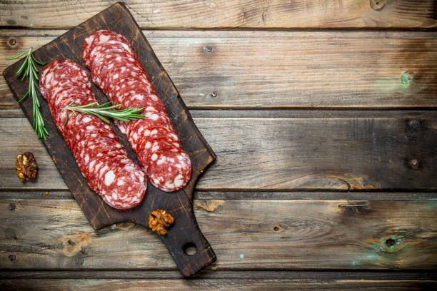 istock Sliced salami with rosemary and walnuts. 1141520543