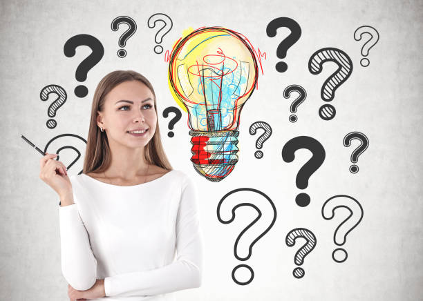 istock Woman with pen, question marks and lightbulb 1141521137