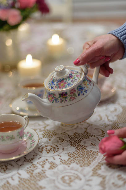 istock Woman pouring tea at home 1141521206