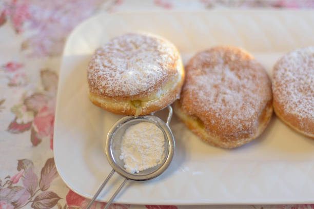 Delicious Paczki pastries for Fat Tuesday on white plate