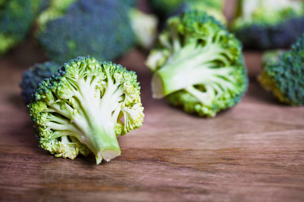 istock Fresh green organic broccoli closeup on wooden table. 1141522176