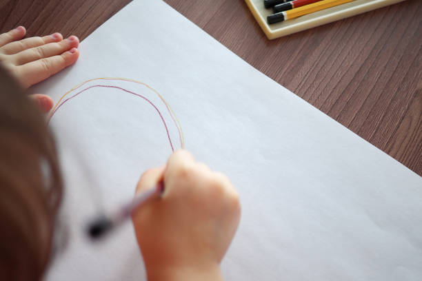 blurred of child draws with pencils, top view