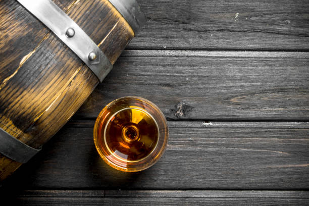 istock Cognac in a glass with a barrel. 1141523228