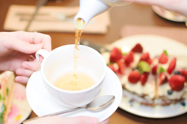 istock Tea party. Women pour green tea into a white Cup 1141523542