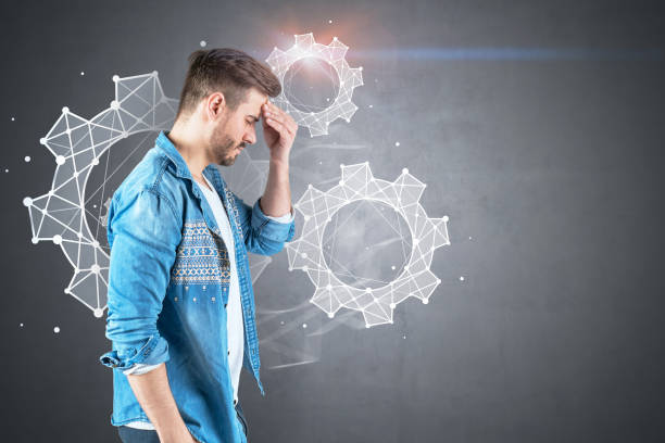 istock Stressed man in jeans shirt, gears 1141523671