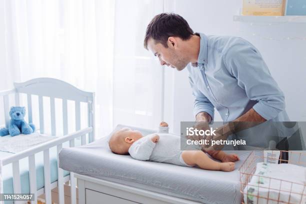 Diaper Changing Stock Photo - Download Image Now - Changing Diaper, Father, 2-5 Months