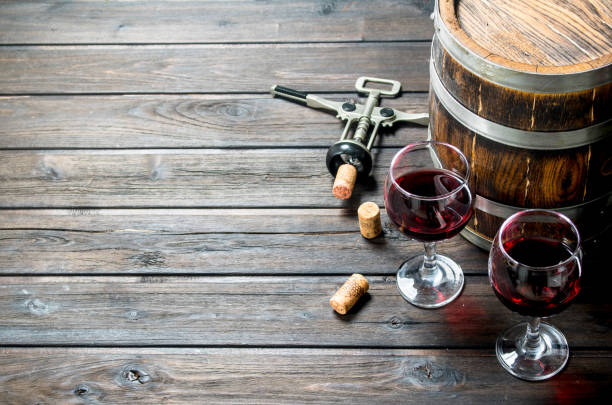 istock Wine background. A barrel of red wine with a corkscrew. 1141524461