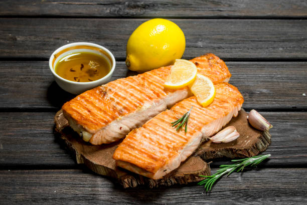 istock Steaks grilled salmon with lemon wedges. 1141524463