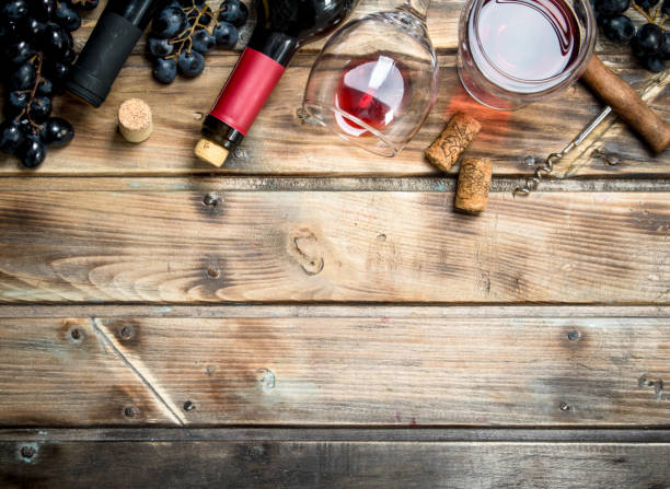 istock Red wine in a glass with grapes and a corkscrew. 1141524716