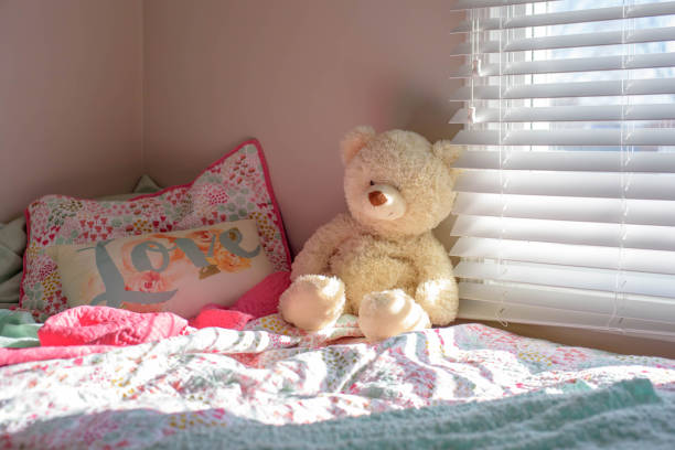 istock Teddy bear on child’s bed in morning sunlight 1141525394