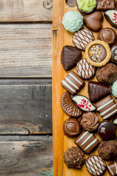 istock Chocolate sweets on a wooden Board. 1141525813