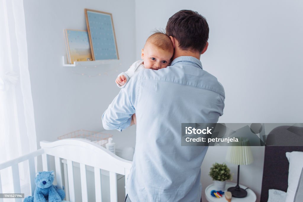 Father and baby son Father carrying baby son in bedroom, they share moment of love 2-5 Months Stock Photo
