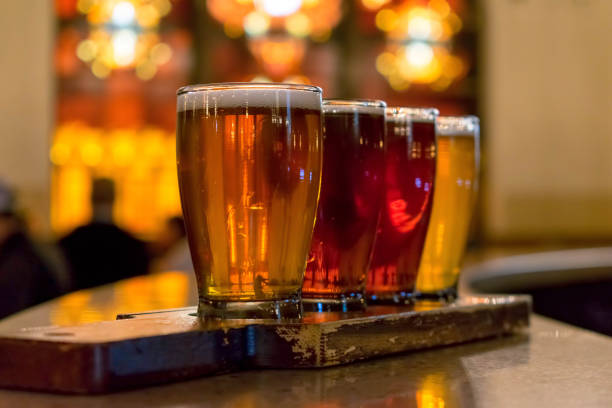 Closeup of craft beer flight on rustic paddle stock photo