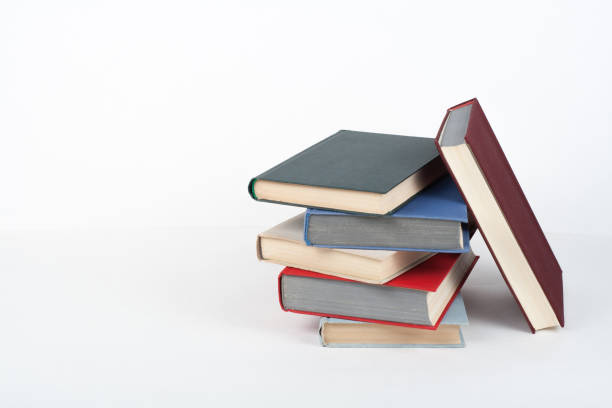 istock Book stack, hardback colorful books on wooden table, white background. Back to school. Copy space for text. Education business concept. 1141527939