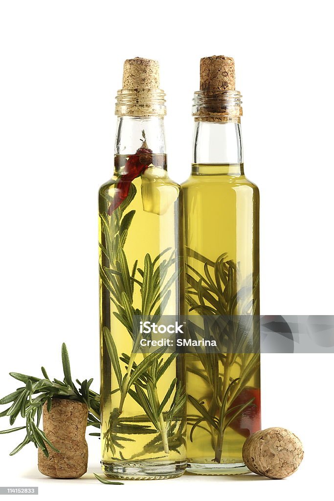 Olive oil with rosemary, garlic and pepper.  Bottle Stock Photo