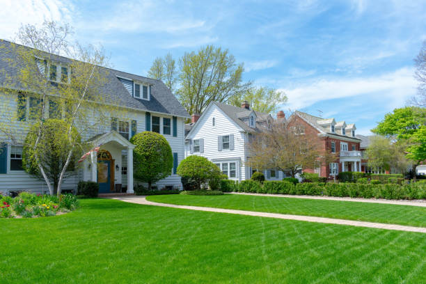 Wide green front lawns in traditional suburban residential neighborhood stock photo