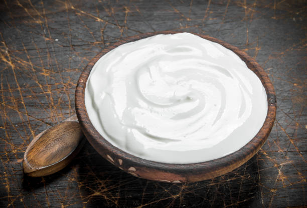 istock Fresh sour cream in bowl with spoon . 1141528912