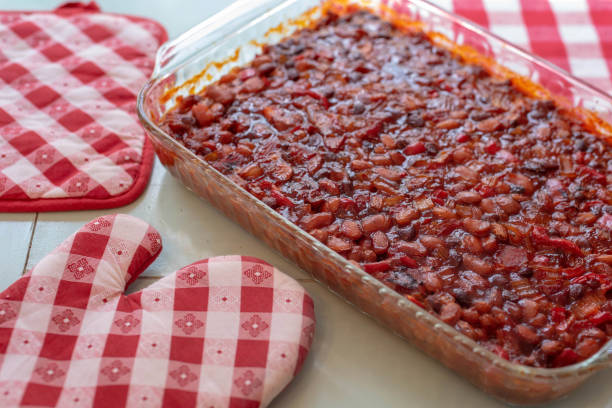 Picnic food - barbecue baked beans Barbecue baked beans and red checked pot holders - homemade picnic food baked beans stock pictures, royalty-free photos & images