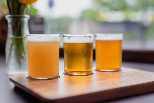 Cold glasses of beer lined up for tasting from a beer flight