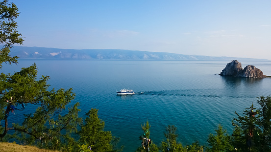 View of Lake Baikal. Mountains, ship, sky. Olkhon Islands, Russia.