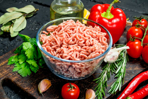 istock Raw minced meat in a bowl with vegetables and herbs. 1141531430