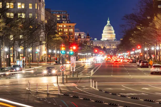 US Capitol Building at sunset along street in Washington, DC, USA