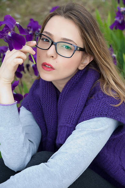 Beautiful, Seductive Blonde Teen with Glasses Touching her Face stock photo