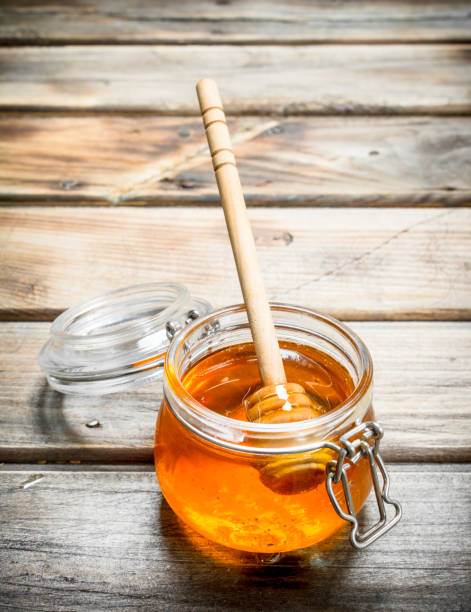 istock Fresh honey in a glass jar with a spoon. 1141533189