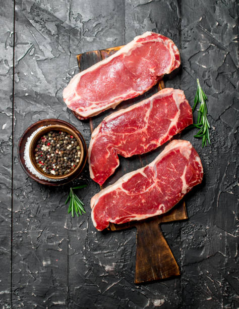 istock Raw marbled beef steaks with salt and spices. 1141533227