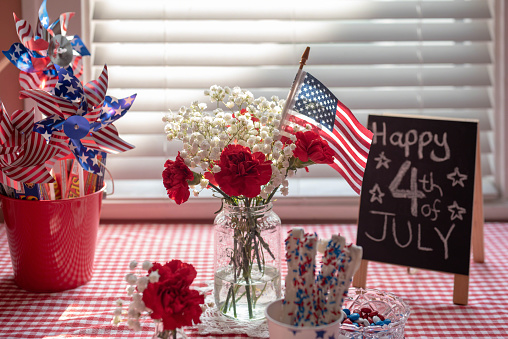 Celebrating Fourth of July with patriotic decorations and party snacks on the table