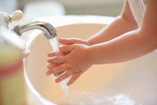 Closeup of little girl washing hands - starting healthy habits early