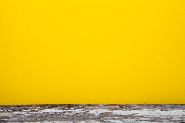 Yellow background and old destroyed wooden board