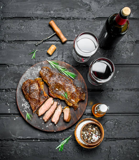 istock Grilled beef steaks with herbs and red wine. 1141535142